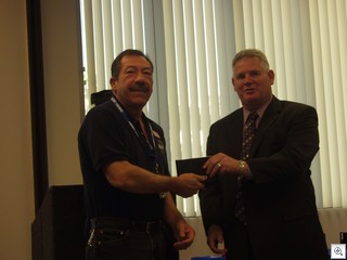 Jack LeVine receives his Citizens Leadership Academy graduation plaque from Chris Knight, the director of  the office of administrative services  for the City of Las Vegas