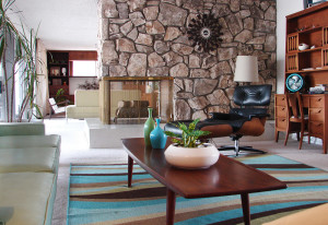 The stacked stone peninsula fireplace separates the living room from the family room. The hearth is original terrazzo from 1963. 